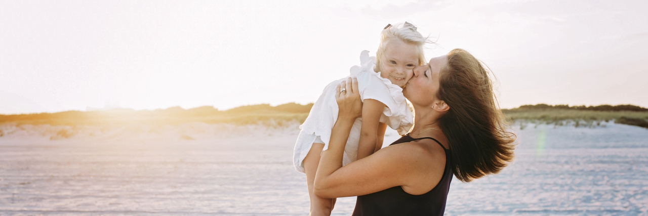 Raising a Child With a Disability Has Made Me Stronger Farah with her child on the beach.