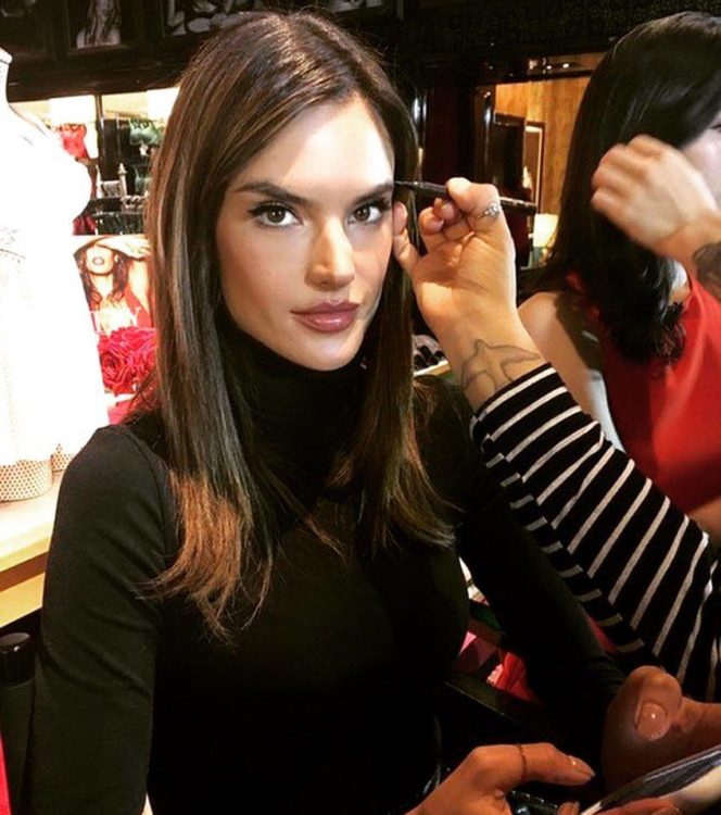 Alessandra Ambrosio looking at camera getting makeup done