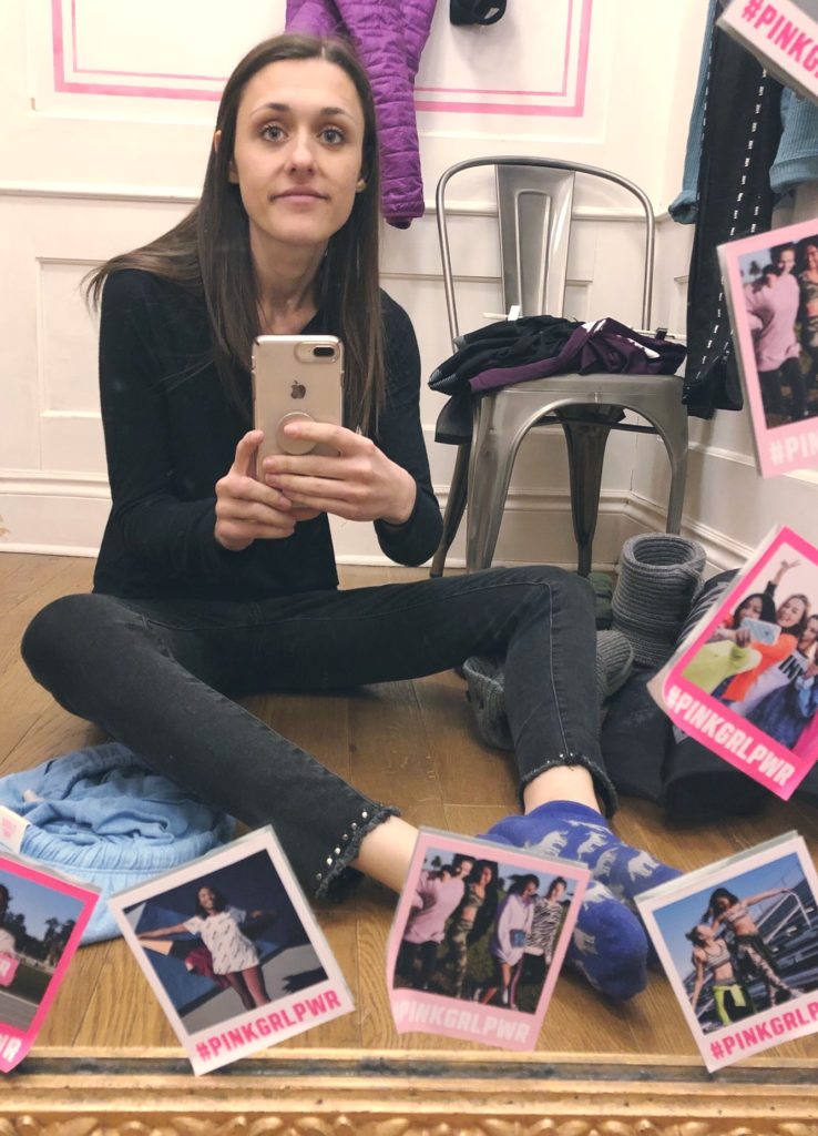 photo of woman with anorexia sitting on floor of dressing room taking selfie in mirror