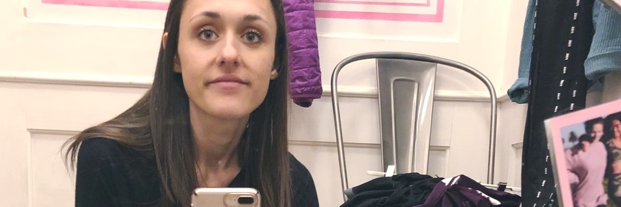 What This Photo Taken Before Eating Disorder Treatment Shows photo of contributor with anorexia looking at camera while sitting on floor of dressing room