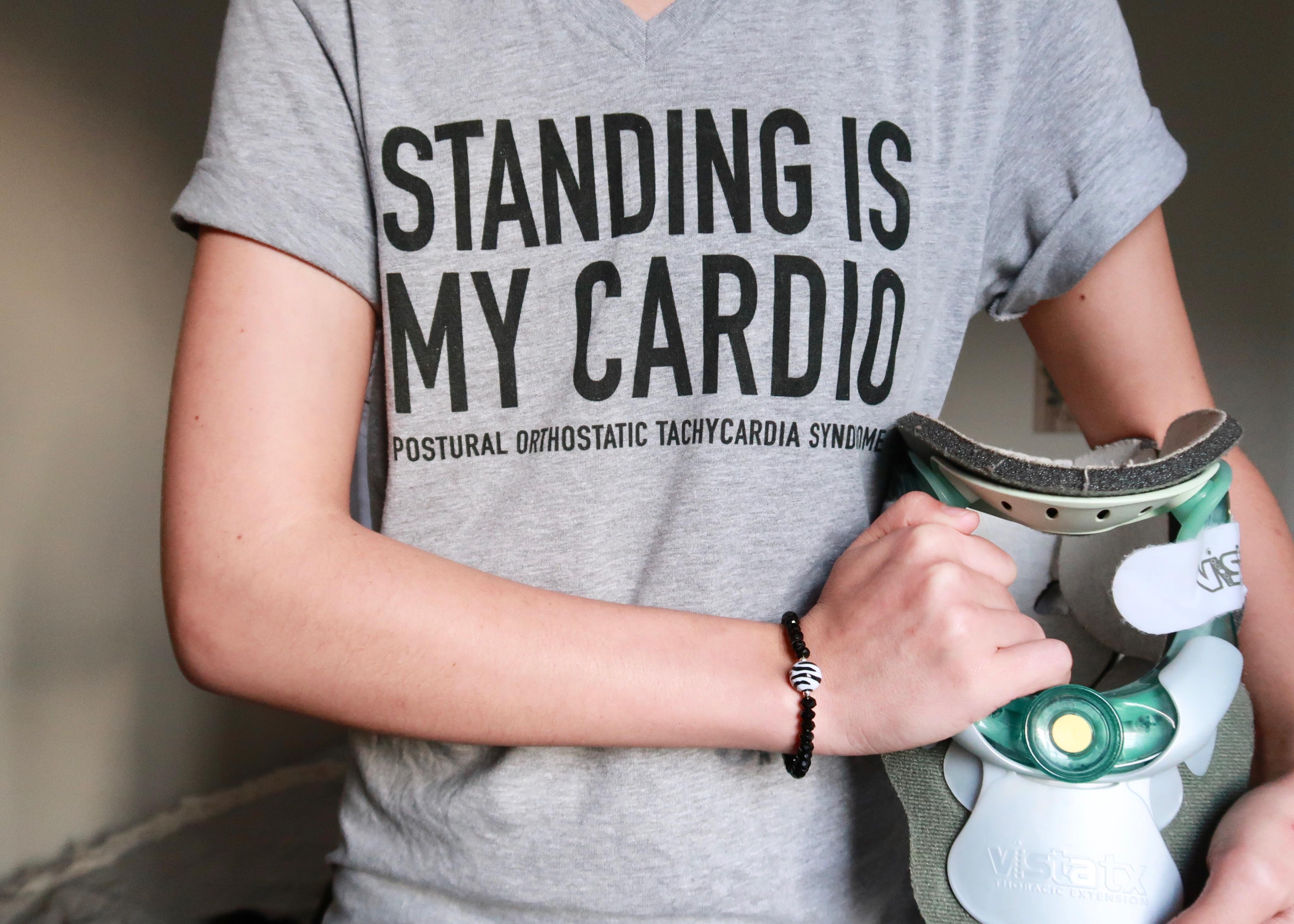 Jennifer wearing a t-shirt that says "standing is my cardio."