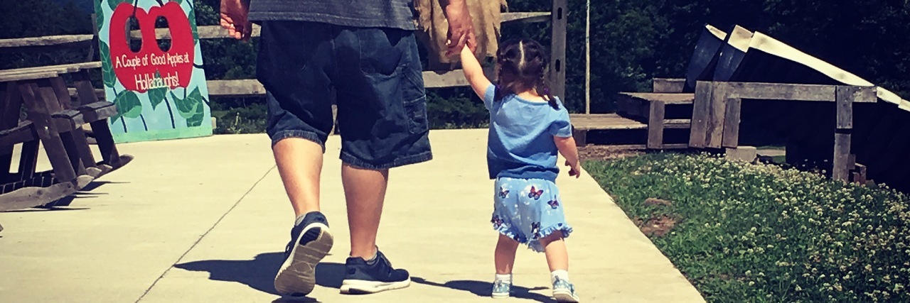 Encouraging Children With Down Syndrome Kelly's daughter walking with her father.