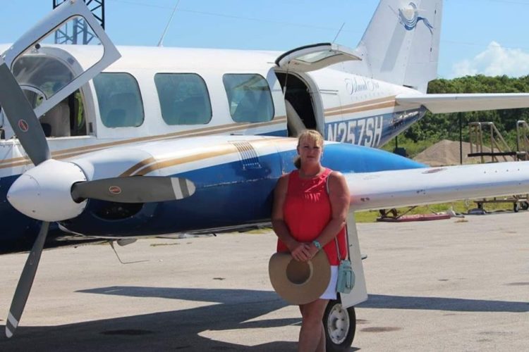 woman standing in front of plane