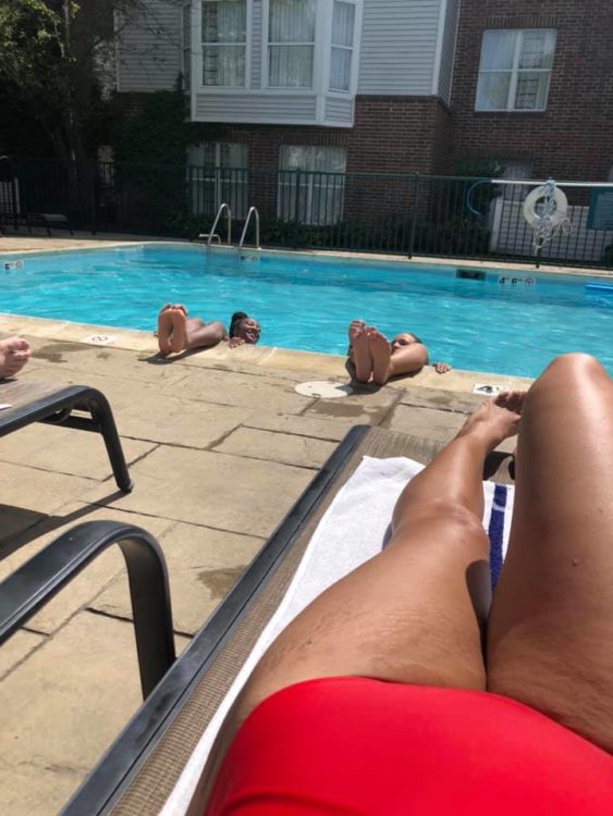 Woman legs lounging by the pool