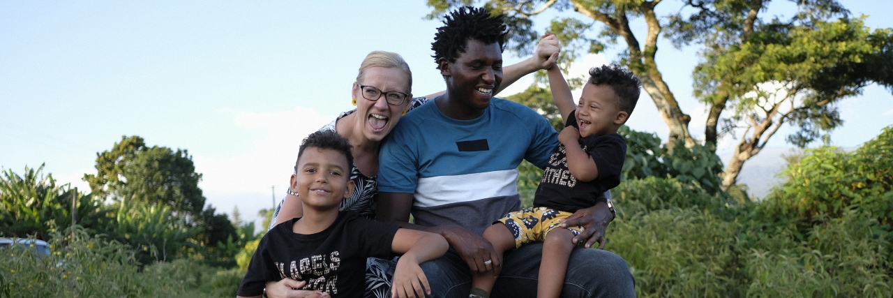 Finding Hope Through Seeing Other Down Syndrome Families Hayley's family smiling outdoors.