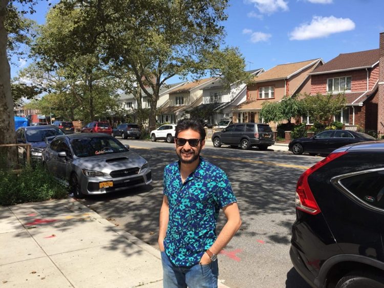 man in hawaiian shirt smiling at the camera