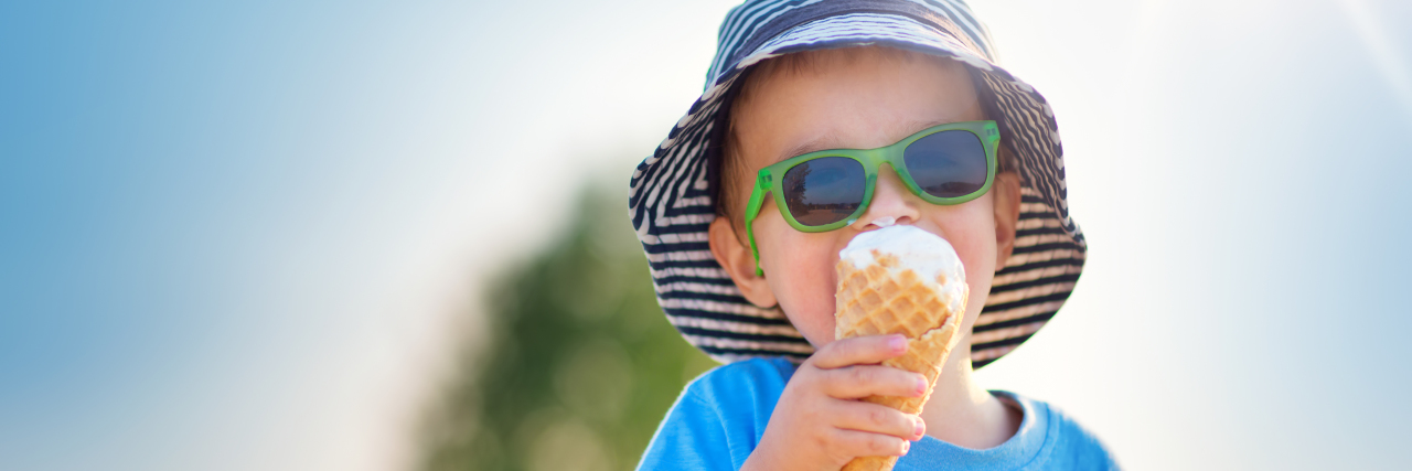 Why Oral Immunotherapy Was the Right Choice for My Son With a Food Allergy Happy child eating ice cream outdoors in summer.