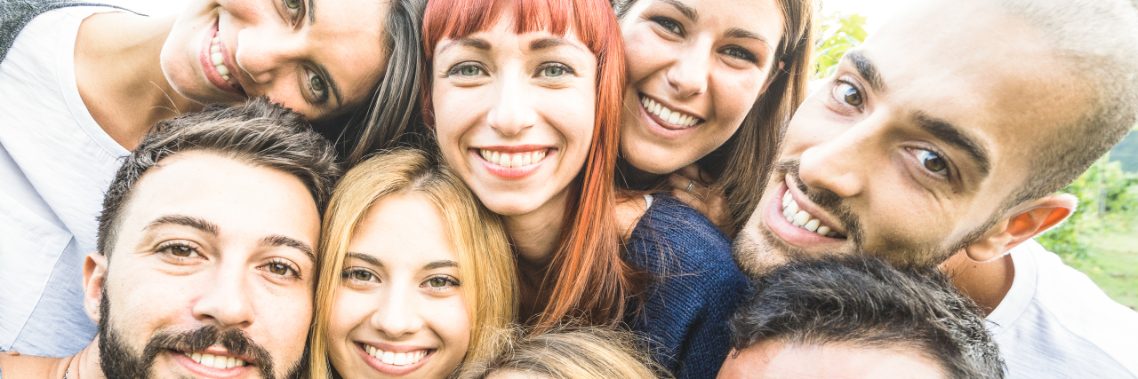 Group of friends posing for photo.