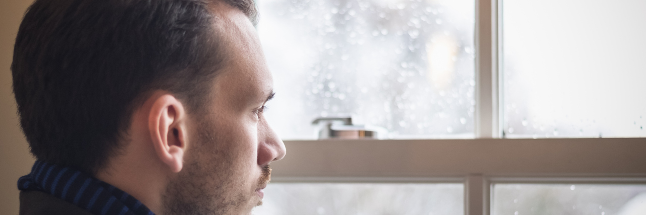 Bipolar Disorder: Living Through a Mixed Episode A man stands in front of a window and stares outside.