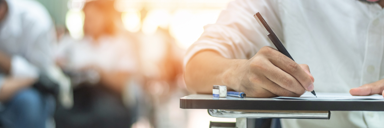 The Difficulty of Getting Learning Disability Evaluations as an Adult Man taking school exam.