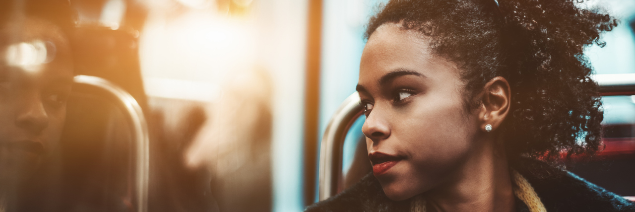 Breaking Free From Perfectionism A woman rides along while intently staring out the window.