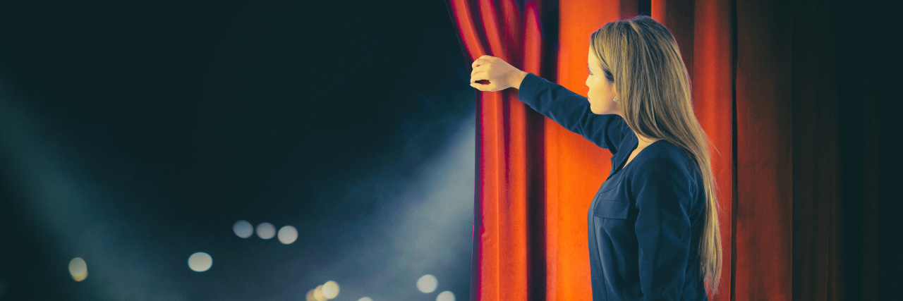 The Joys and Challenges of Being a Performer With a Disability Woman opening red curtains on theater stage.