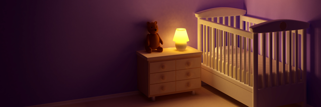 a baby's room with a crib and a night light