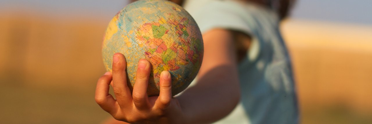 The Benefits of Medical Deferred Action in the United States Close-up of a child holding a small globe