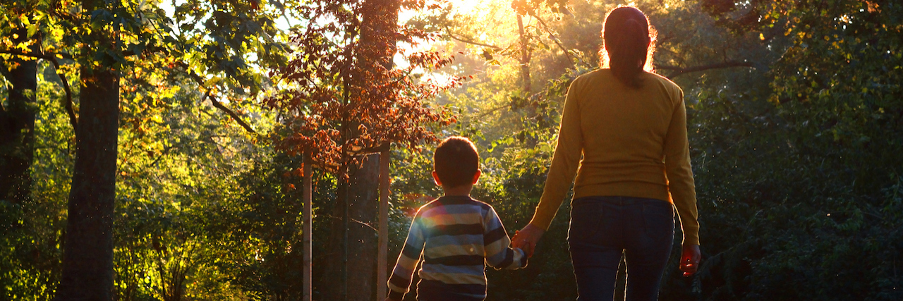 Parenting a Child With an Invisible Illness Song holding hands with mother in nature