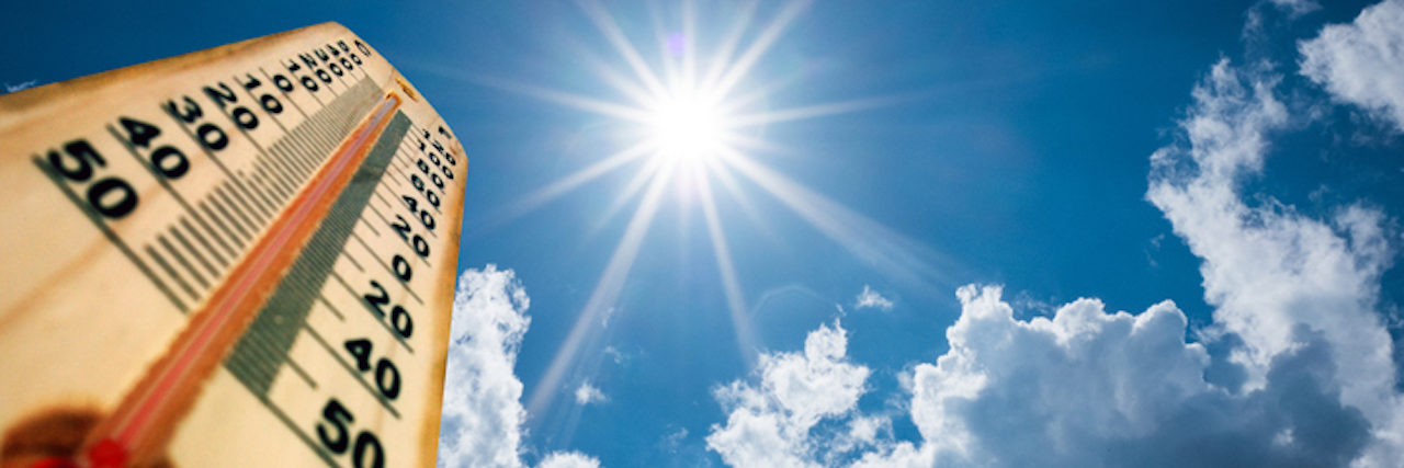 How Heat and Climate Change Interacts With Mental Health Drugs Thermometer Sun high Degres. Hot summer day. High Summer temperatures