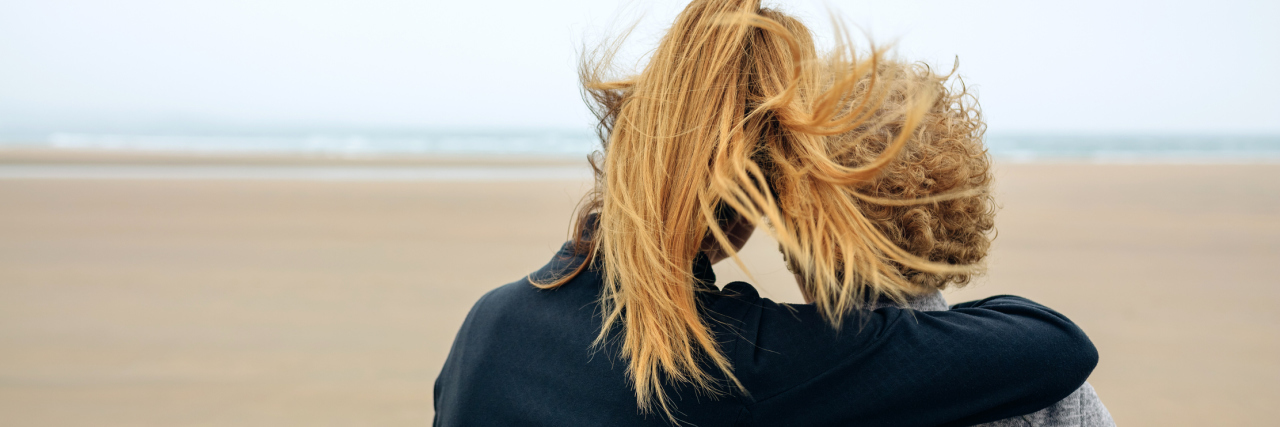 Lessons Learned From My Mom's Metastatic Breast Cancer Diagnosis Back view of senior and young woman looking at sea on the beach in autumn