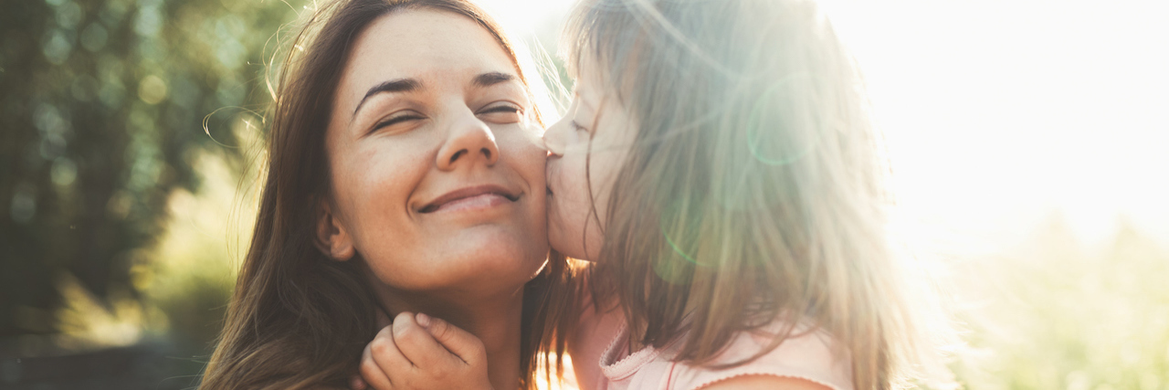 Parenting Clichés That Don't Apply to Rare Disease Parents A young girl kissing her mom on the cheek