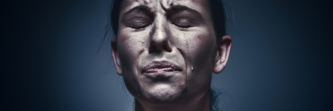 What It’s Like to Have a Bad PTSD Day close up portrait of crying woman with eyes closed