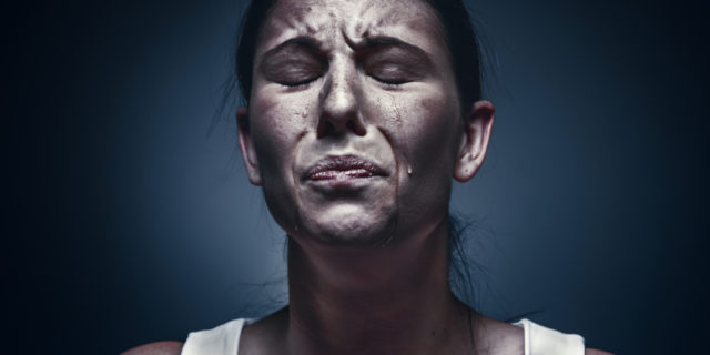 close up portrait of crying woman with eyes closed