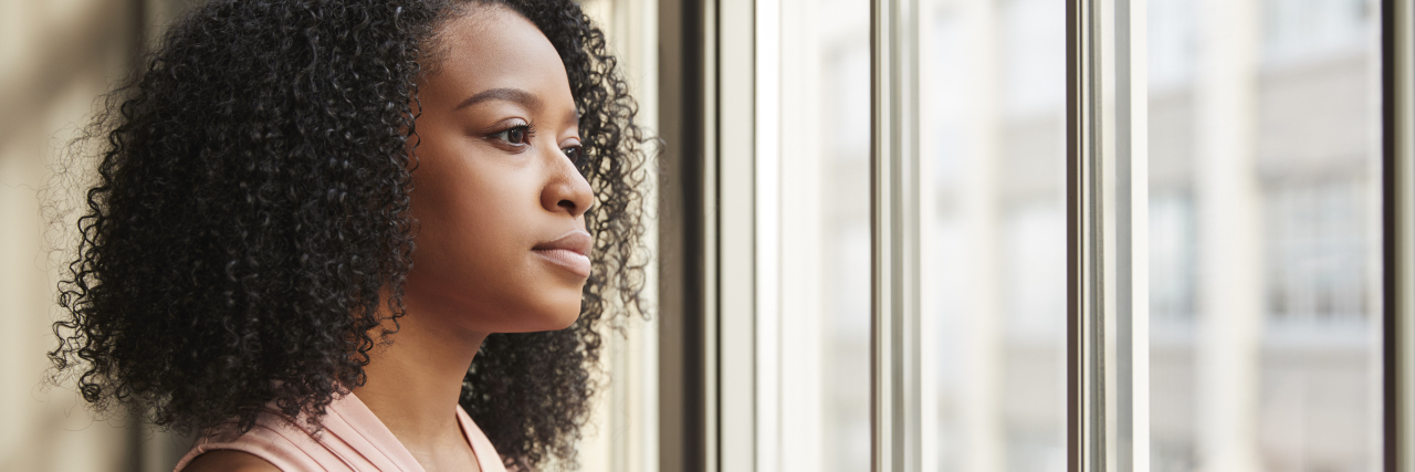 I'm Too Sick to Go to Church Black woman with pink blouse looking out of window