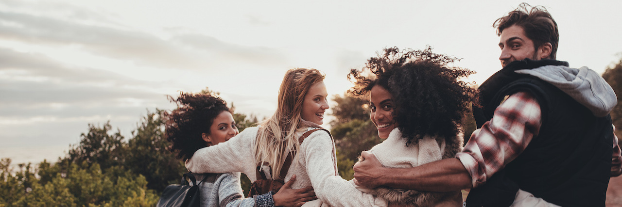 Accepting My Recovery Support System for an Eating Disorder Group of man and women walking together in countryside. Happy young people turning around and looking at camera.