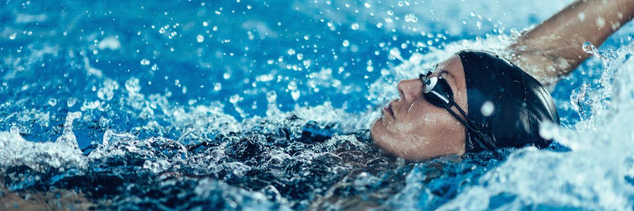 Discovering and Treating My Thrombosis A woman swimming the backstroke in a pool