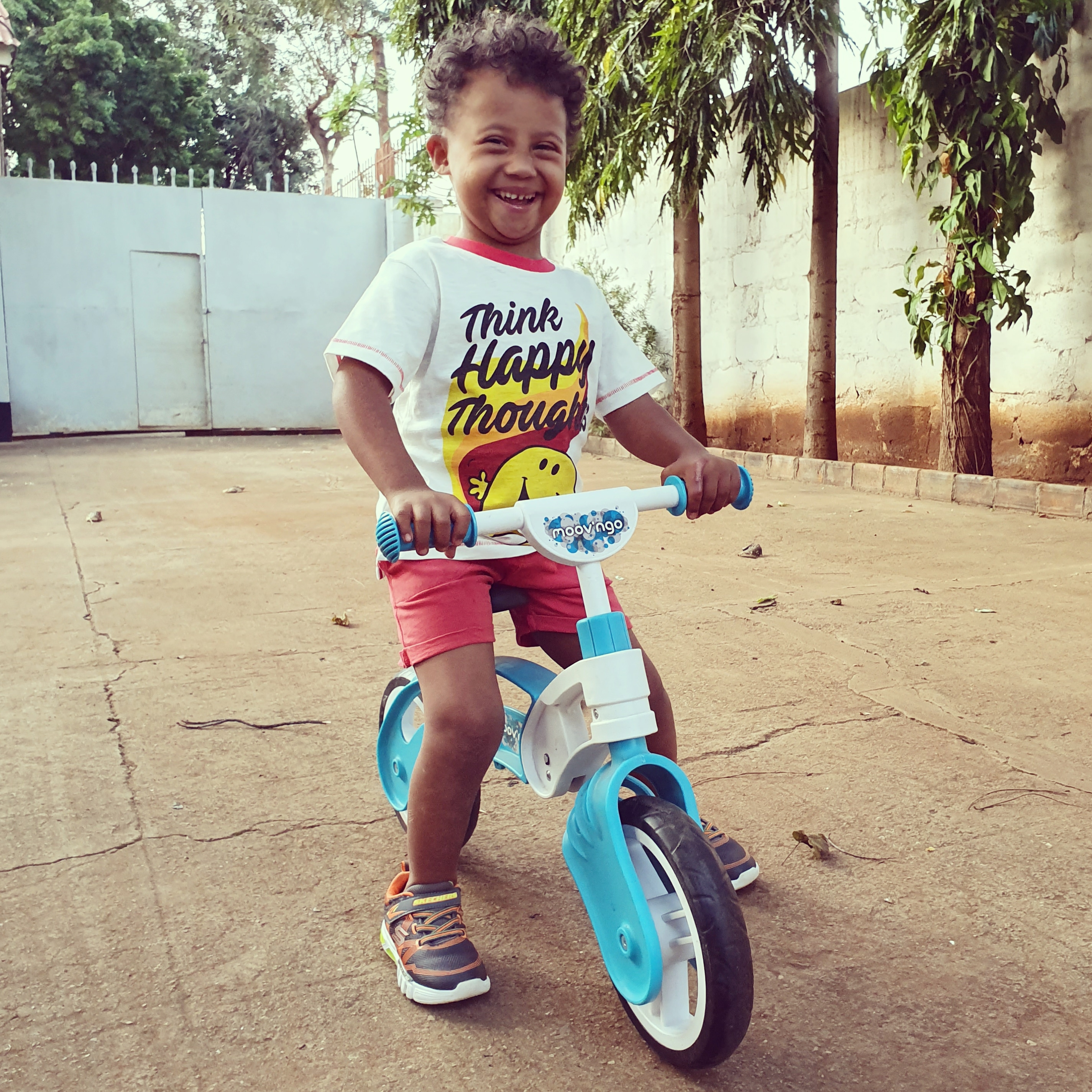 Hayley's son riding a tricycle.