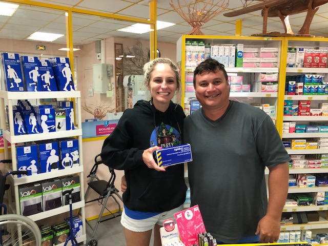 man and woman holding box of insulin in pharmacy