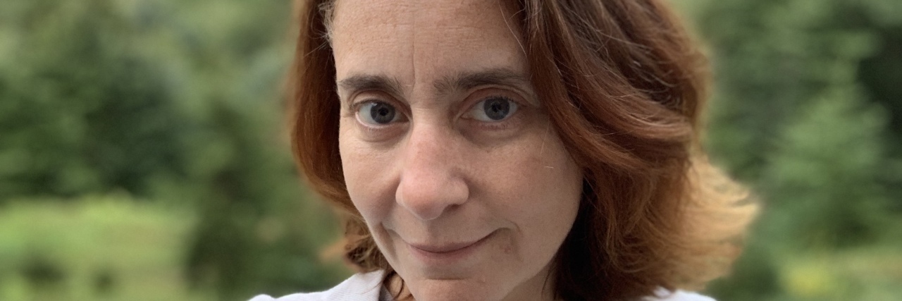 A Letter to Myself When I'm Feeling Depressed A woman stands posing and looking into the camera.