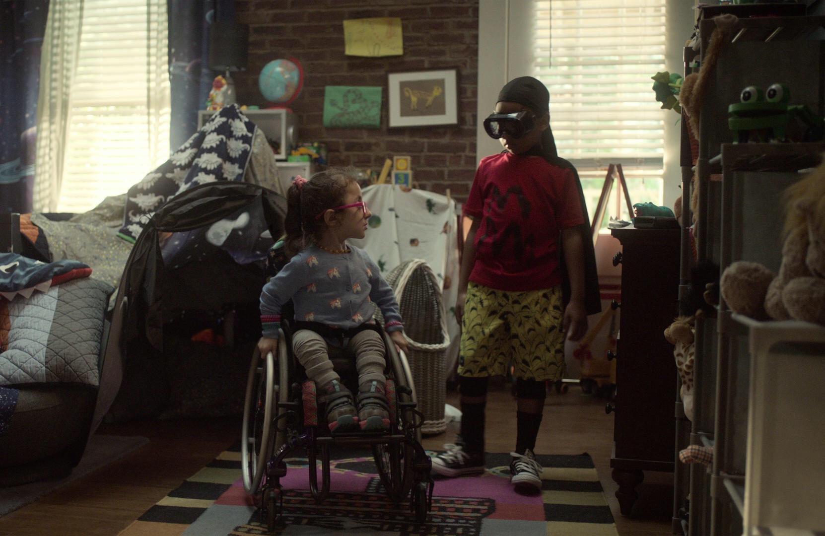 Esperanza (Sammi Haney) helps Dion (Ja'Siah Young) with his superhero costume in the Netflix series "Raising Dion."