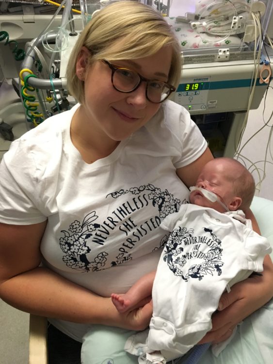 Mari being held by her mother in the hospital