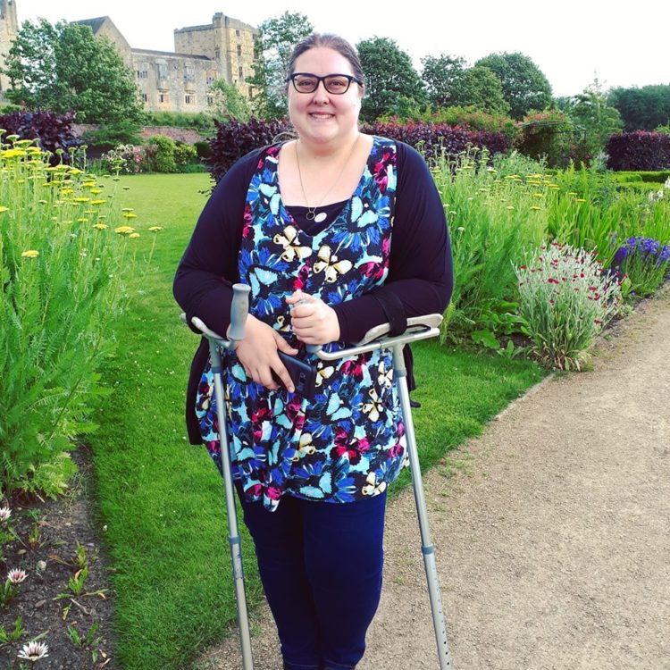 woman standing in front of garden smiling