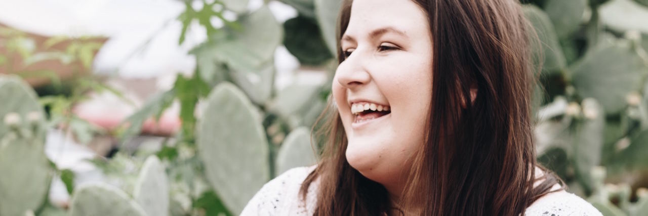 Chronic Illness: How to Cope With Gaining Weight A woman standing outside and laughing