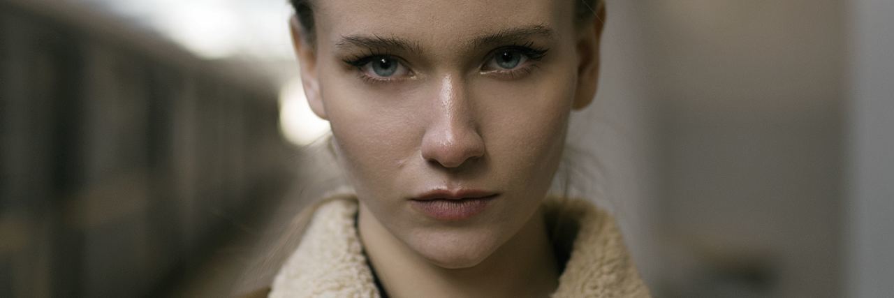 I Wasn’t Ready for What Came After My Bipolar Diagnosis photo of woman with blonde hair looking stern into camera