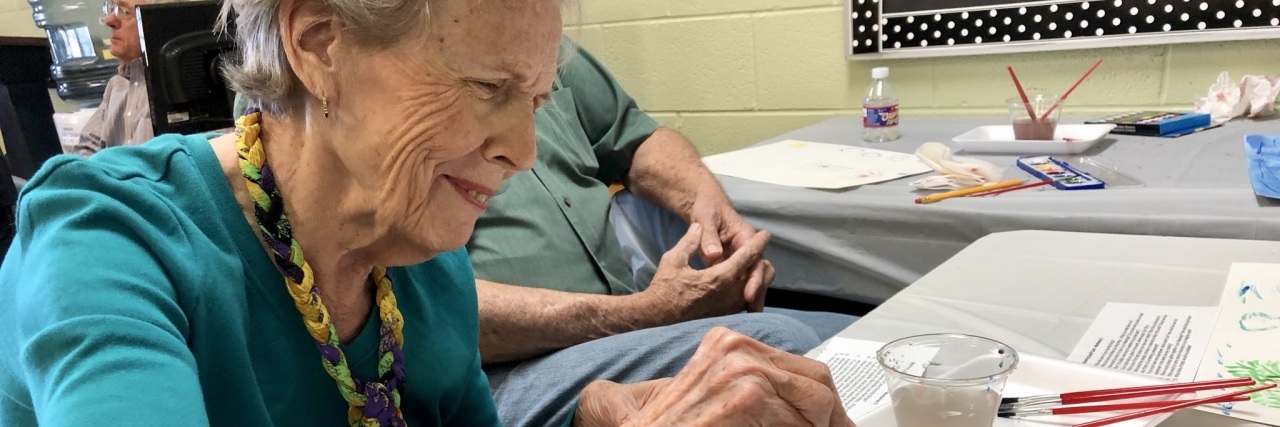 How Davis Phinney Foundation's Sidekicks Builds Parkinson's Community woman painting with watercolors