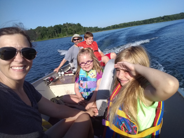 Willow riding in a boat with her family.