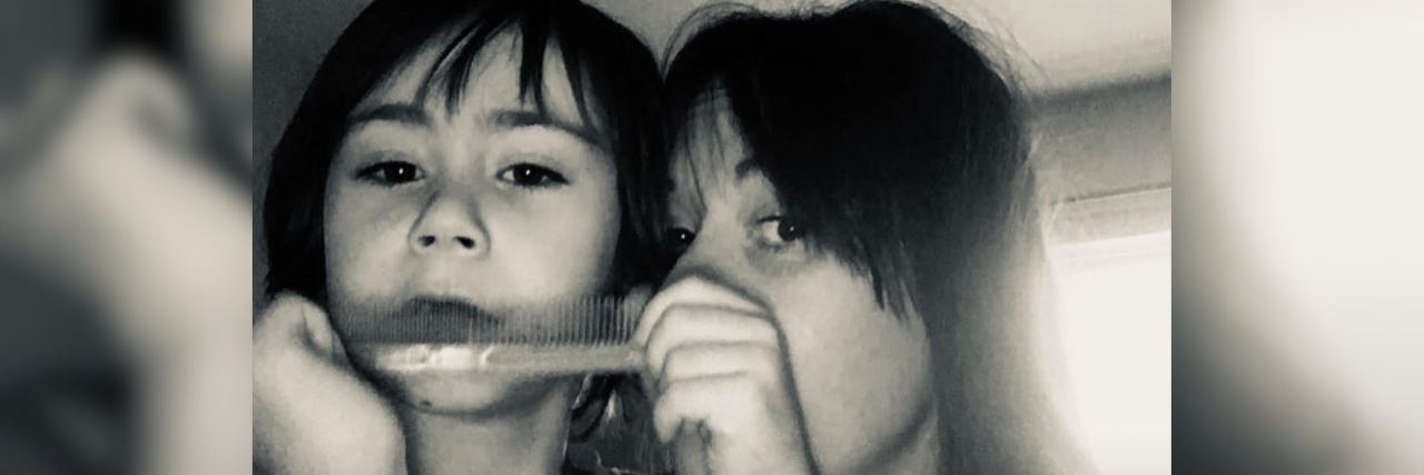 Accepting My Child's Autism Jodie with her son Sam, who is playing with a comb.