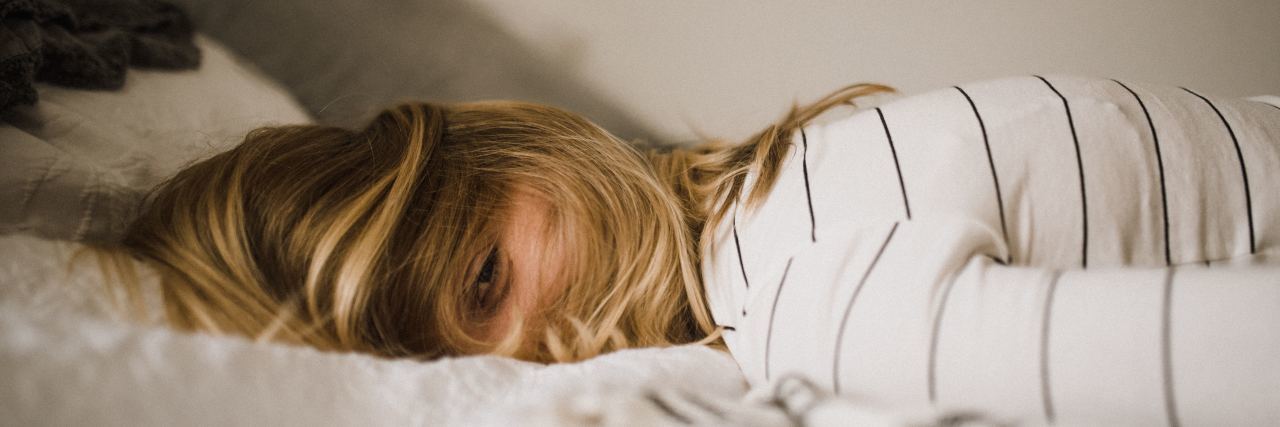 When Your Physical Health Turns Everything Into a Catch-22 woman lying on bed