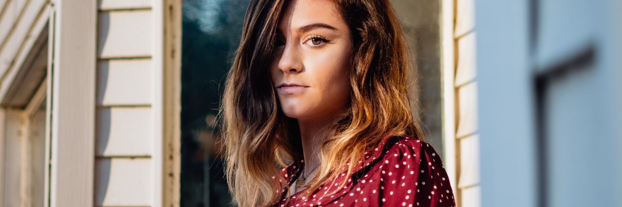 How Hurtful Family Responses to Sexual Violence Affects Survivors photo of woman on porch in golden light looking into camera