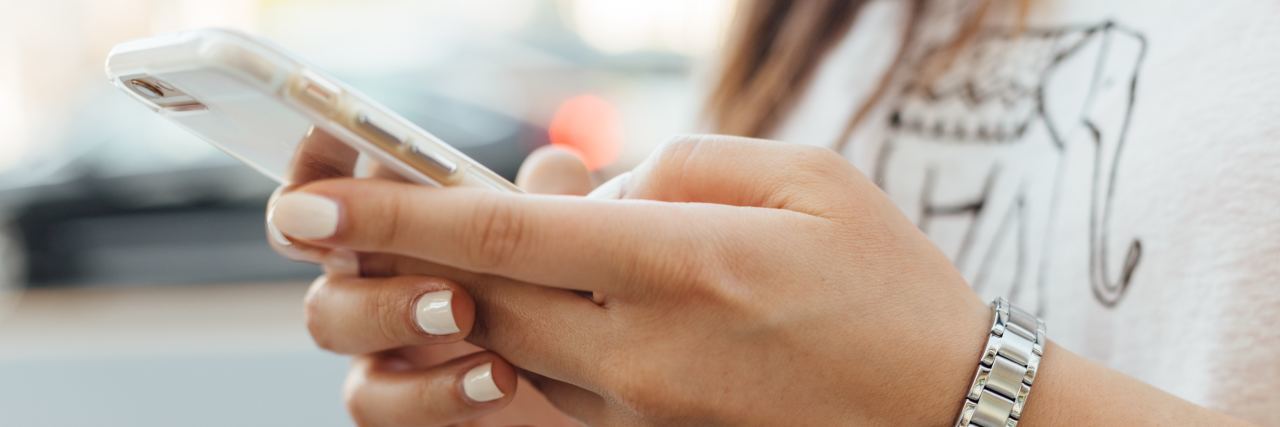 Emojis Can Be a Simple Way to Reach Out for Mental Health Support close up photo of woman's hands holding smartphone, typing