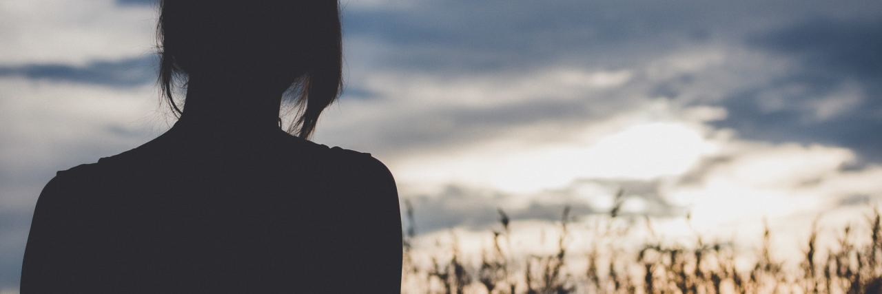 How to React to Someone's Confession of Suicidal Thoughts photo of woman silhouetted against cloudy sky