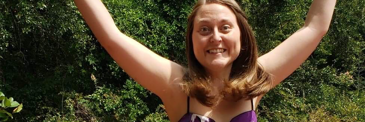 What This Happy Photo Doesn’t Show About My Life With Chronic Illness photo of contributor, Samantha Bowick, jumping into the air and smiling