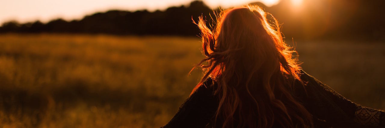 Woman outside in nature at sunset