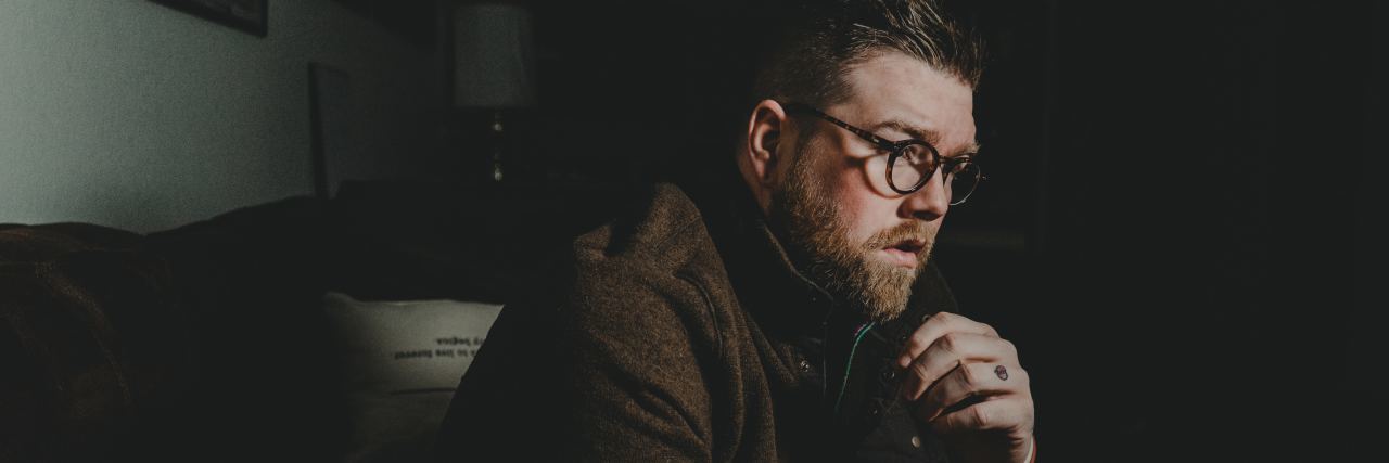 There’s Such a Thing as Depression Counseling? man sitting in dark room