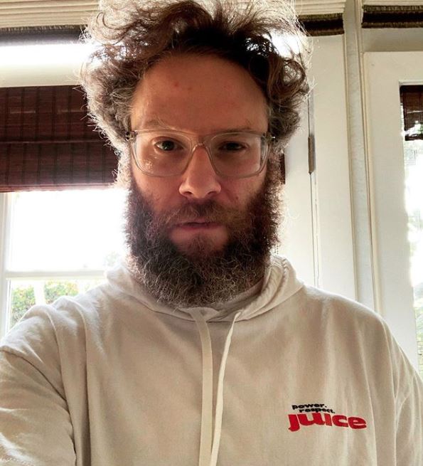 seth rogan with glasses in sweatshirt looking at camera