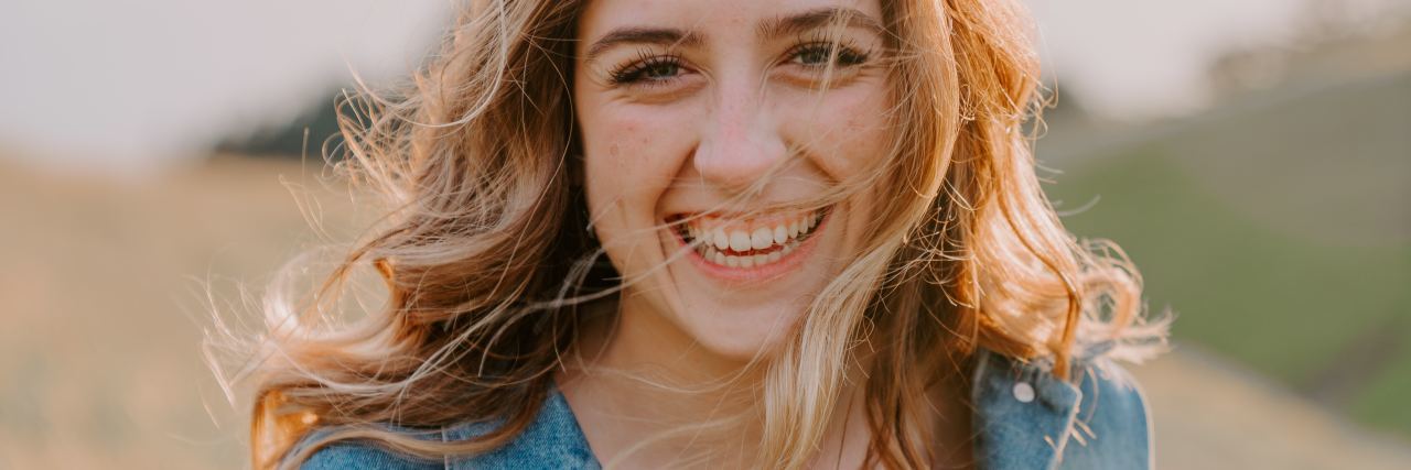 Treatment for Lyme Disease Also Helped My Depression photo of blonde woman outside in sunlight, smiling for camera