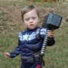 Adam's son dressed as Captain America holding Thor's hammer.