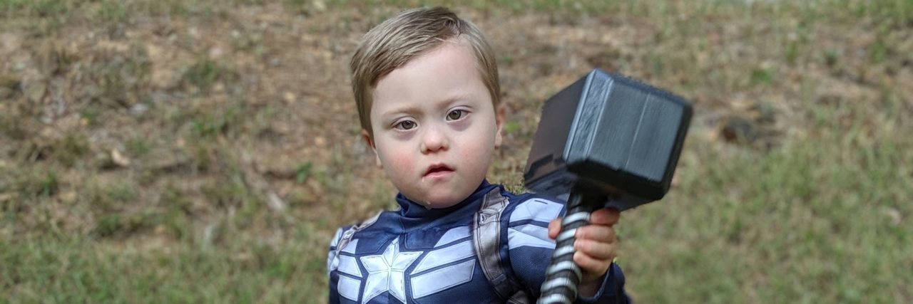 Boy With Down Syndrome's Halloween Costume Fights Stereotypes Adam's son dressed as Captain America holding Thor's hammer.