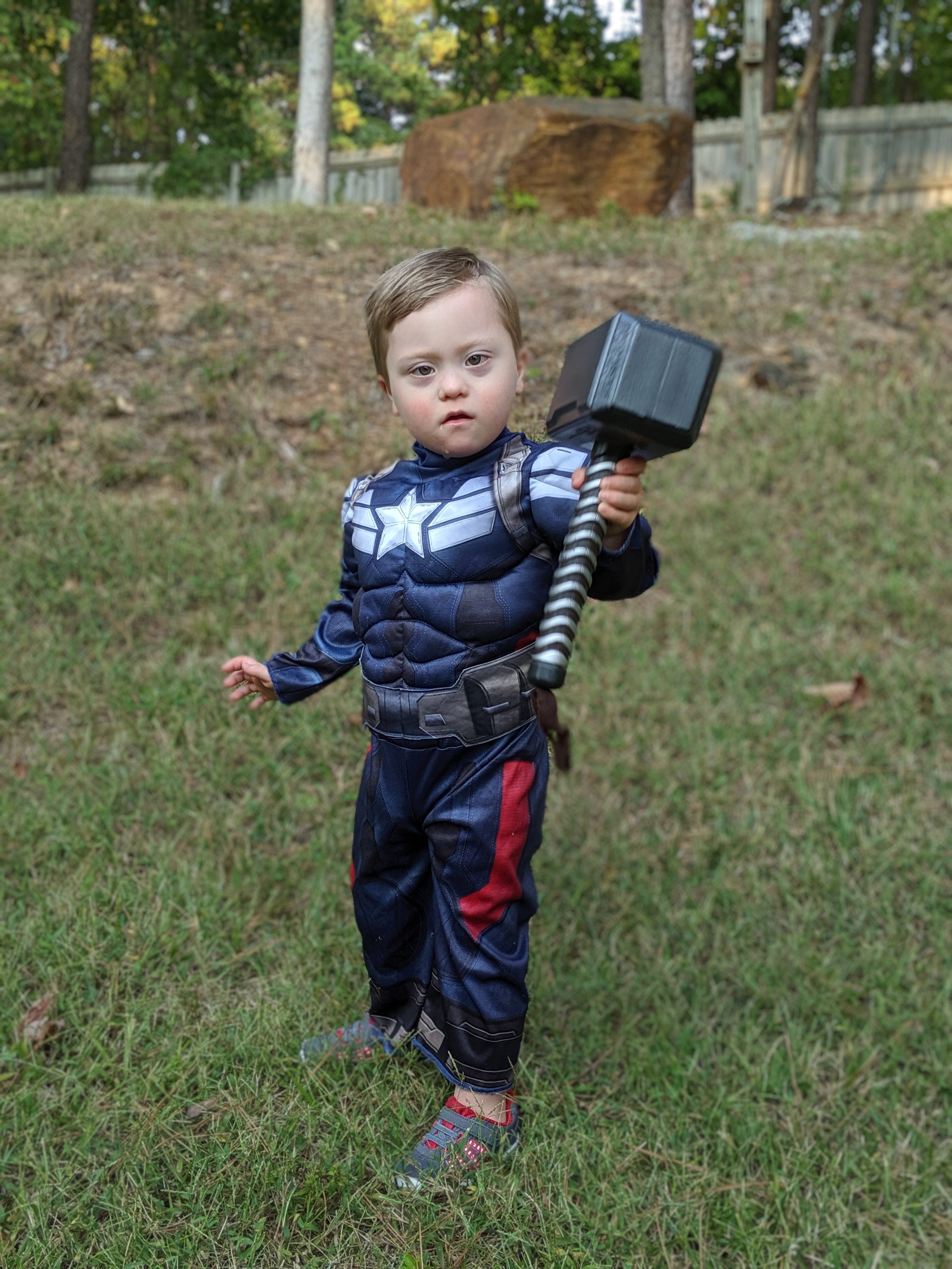Adam's son dressed as Captain America holding Thor's hammer.